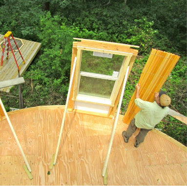 man setting up a yurt and yurt windows