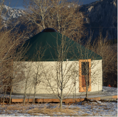 white yurt with a green door