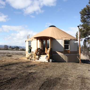 white yurt with a staircase out front