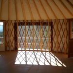 inside of a yurt with an 8 foot window