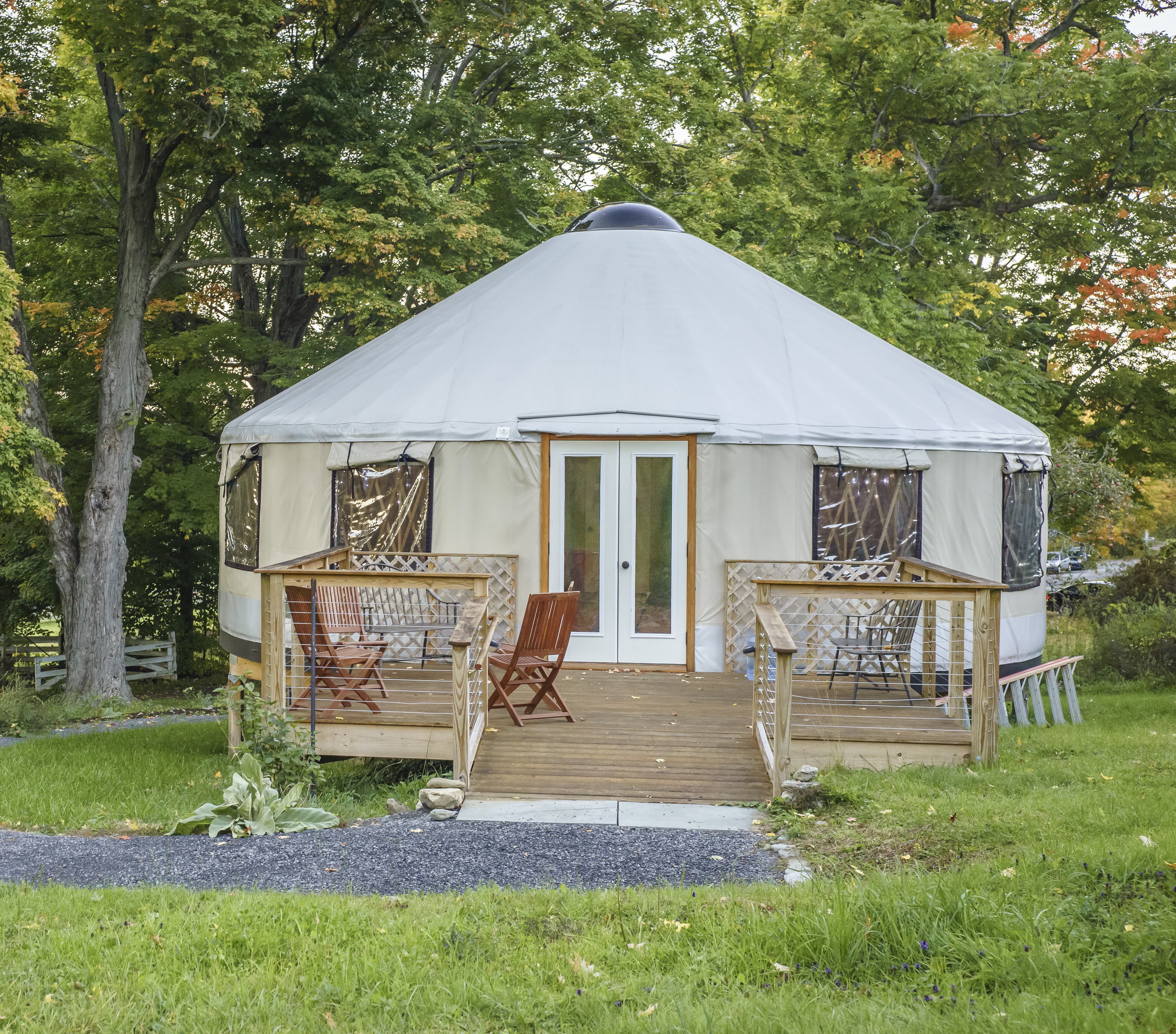 shelter designs yurt with a porch and chairs