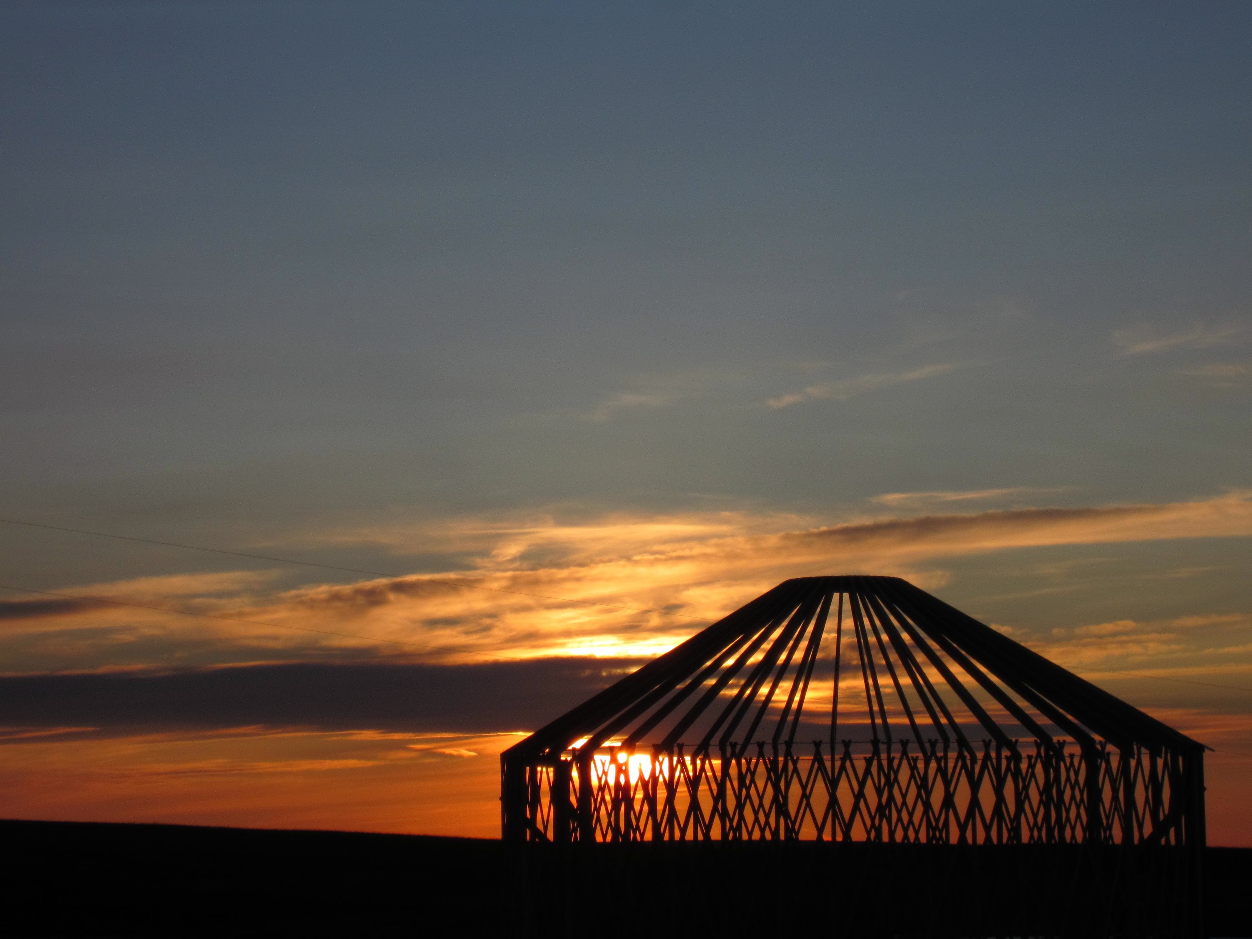 Big sky yurt frame against a sunset