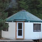 white yurt with a green door
