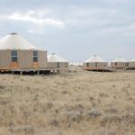 multiple tan yurts on the plains