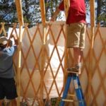 two men setting up a yurt