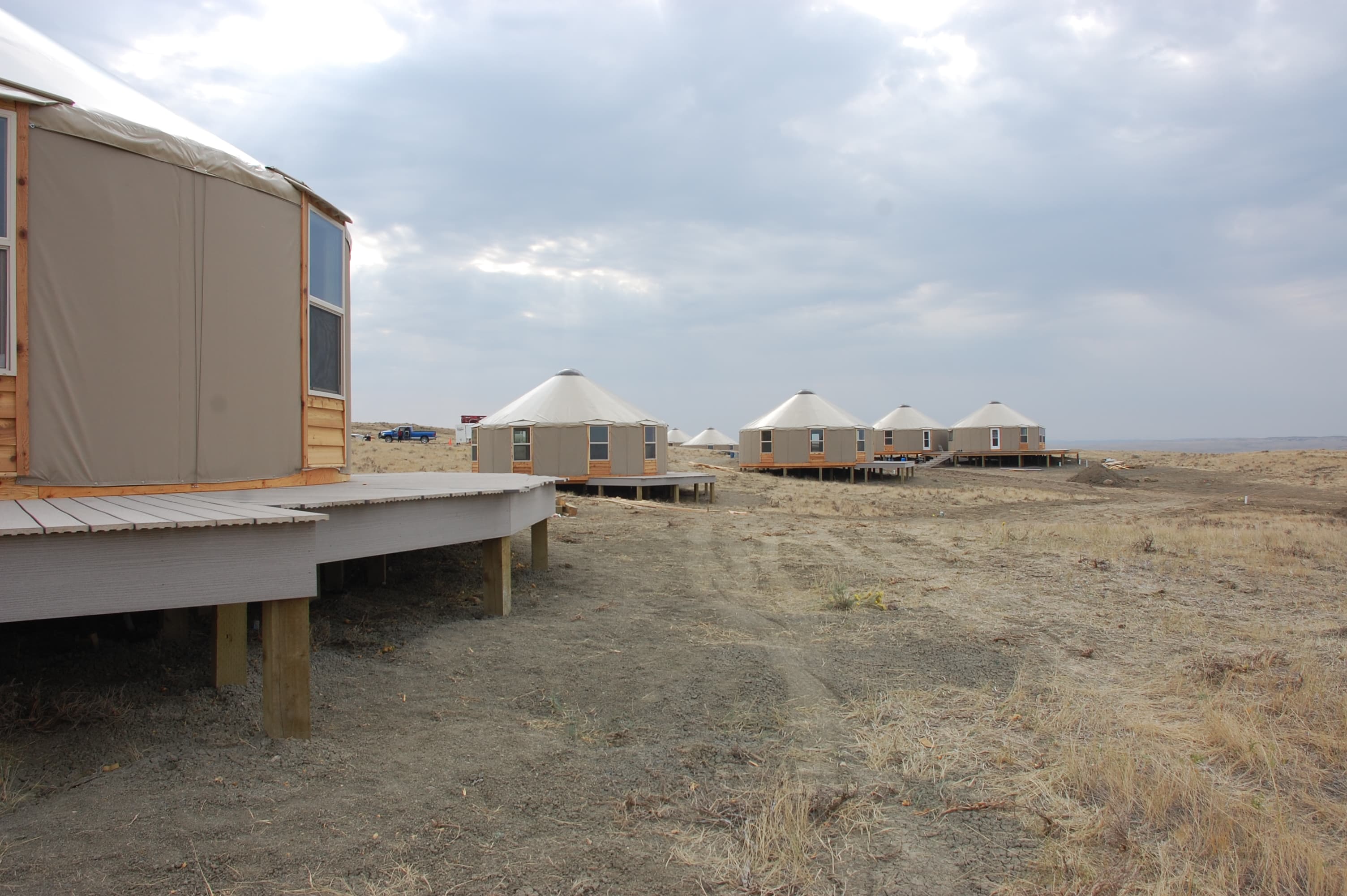 multiple tan yurts on the plains