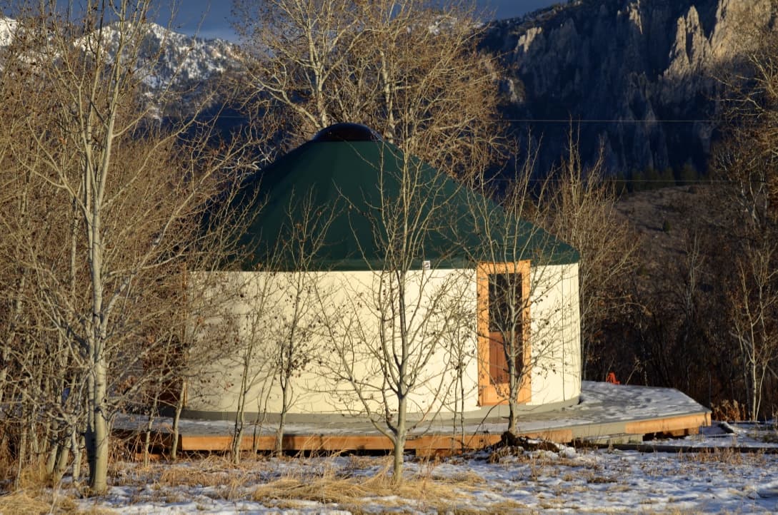 white yurt with a green roof