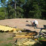 man working on a yurt platform